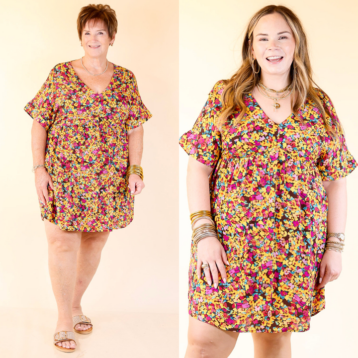 Two women wearing a brown floral dress on a beige background
