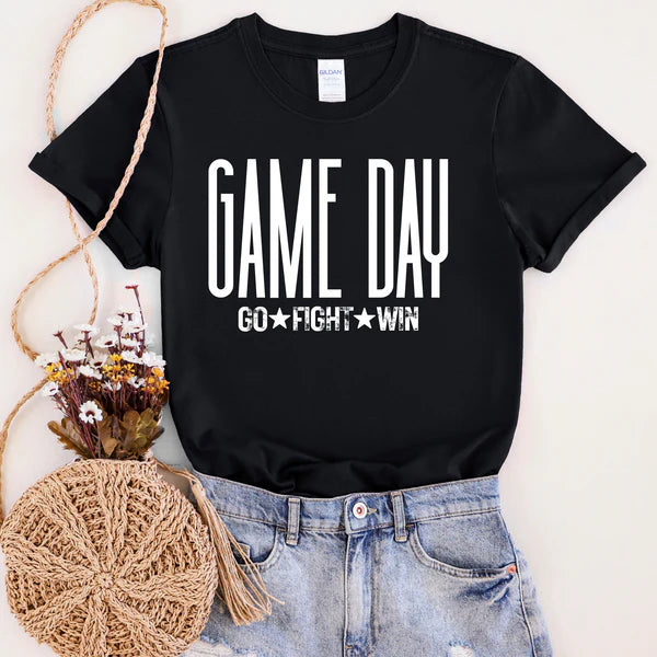 Black t-shirt with 'GAME DAY GO FIGHT WIN' text, paired with jeans and a decorative basket on a light background