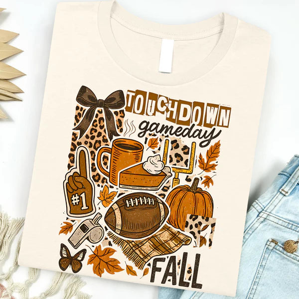 Beige t-shirt with autumn-themed graphics and text on a white background