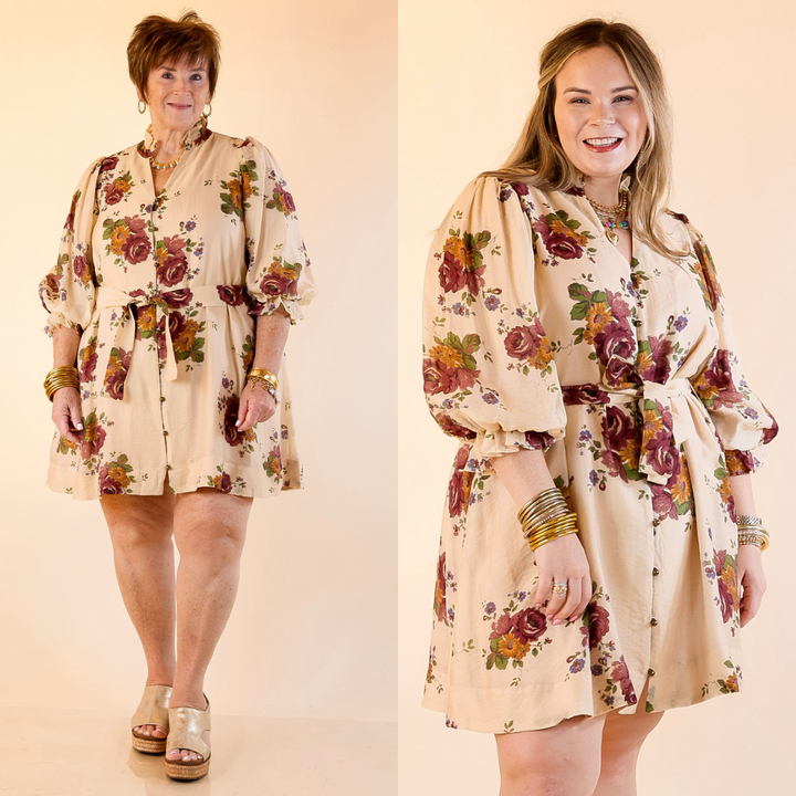 Models are wearing floral dress with belt detail in vanilla cream on a beige background
