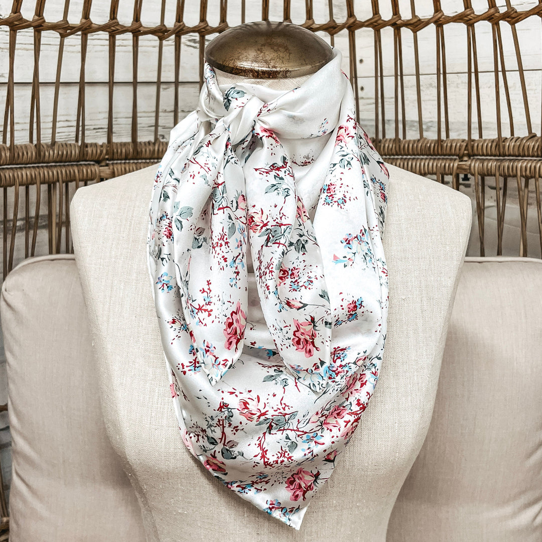 Floral patterned scarf on a mannequin against a wicker chair background