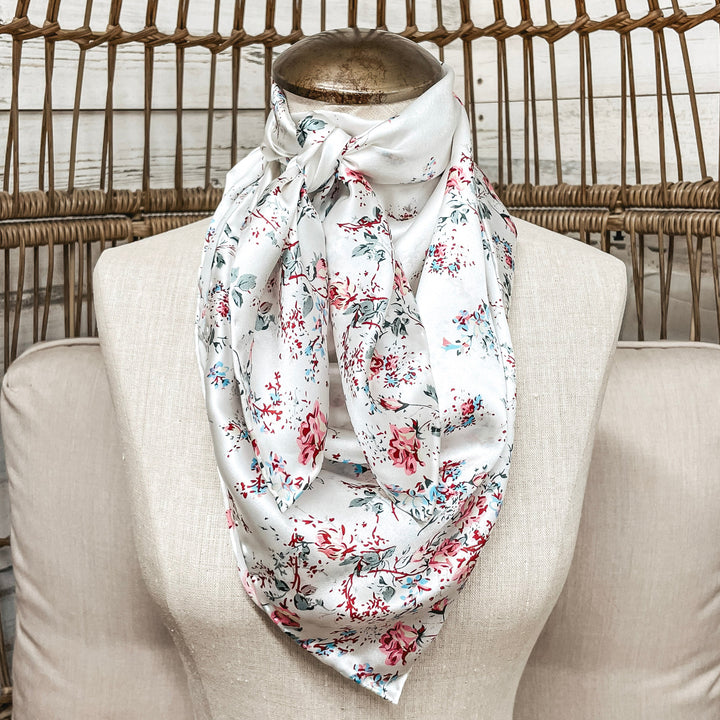 Floral patterned scarf on a mannequin against a wicker chair background