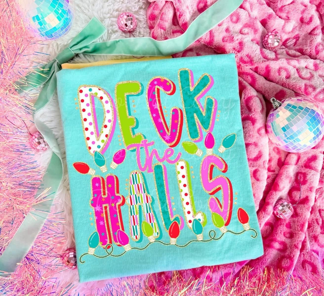 Girly Deck The Halls Lights Christmas graphic tee or sweatshirt on mint green with mixed-pattern Deck the Halls lettering wrapped in Christmas lights