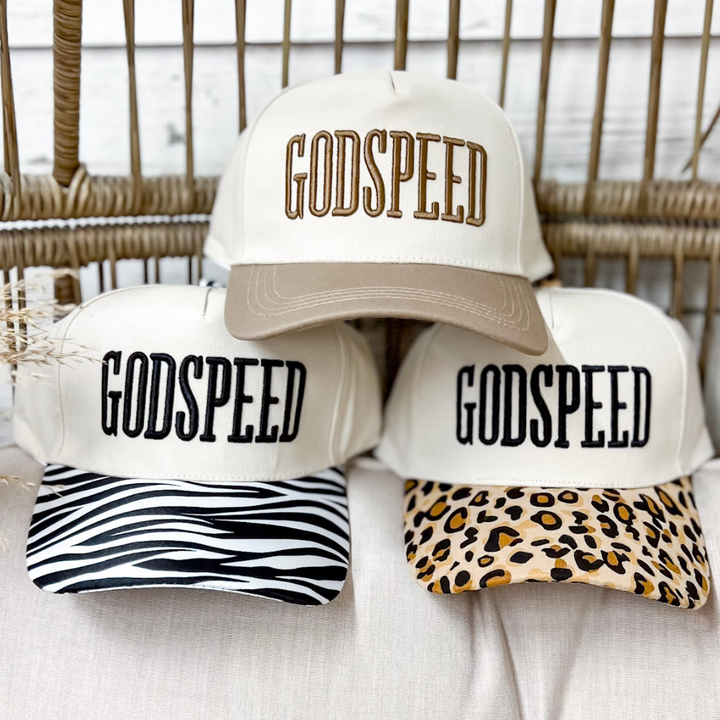 Godspeed embroidered two-tone canvas trucker cap available in Mocha, Zebra, and Leopard with a structured cream crown, curved brim, and adjustable snapback closure.