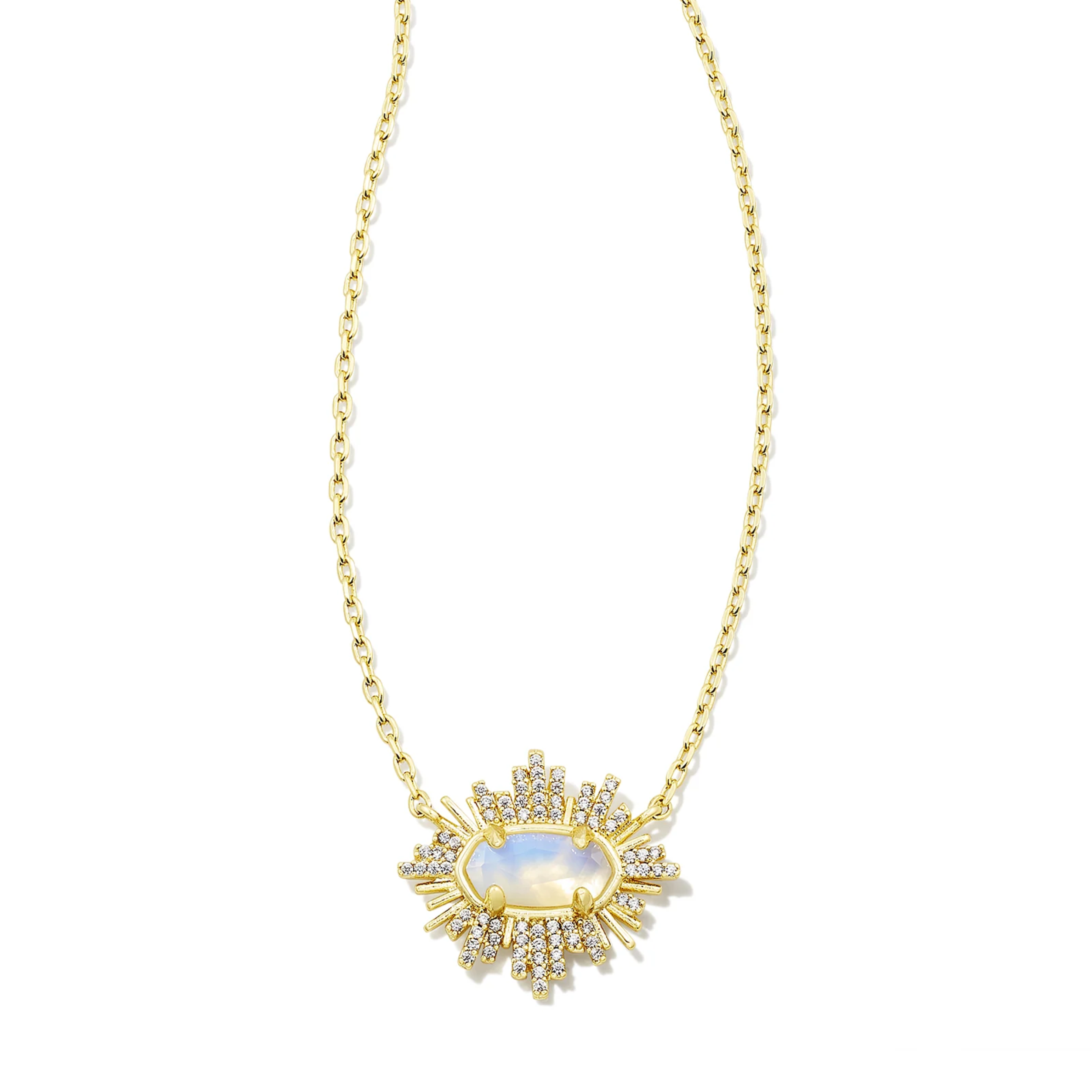 This grayson Sunburst Gold Frame Pendant Necklace in Iridescent Opalite illusion by Kendra Scott is pictured on a white background.