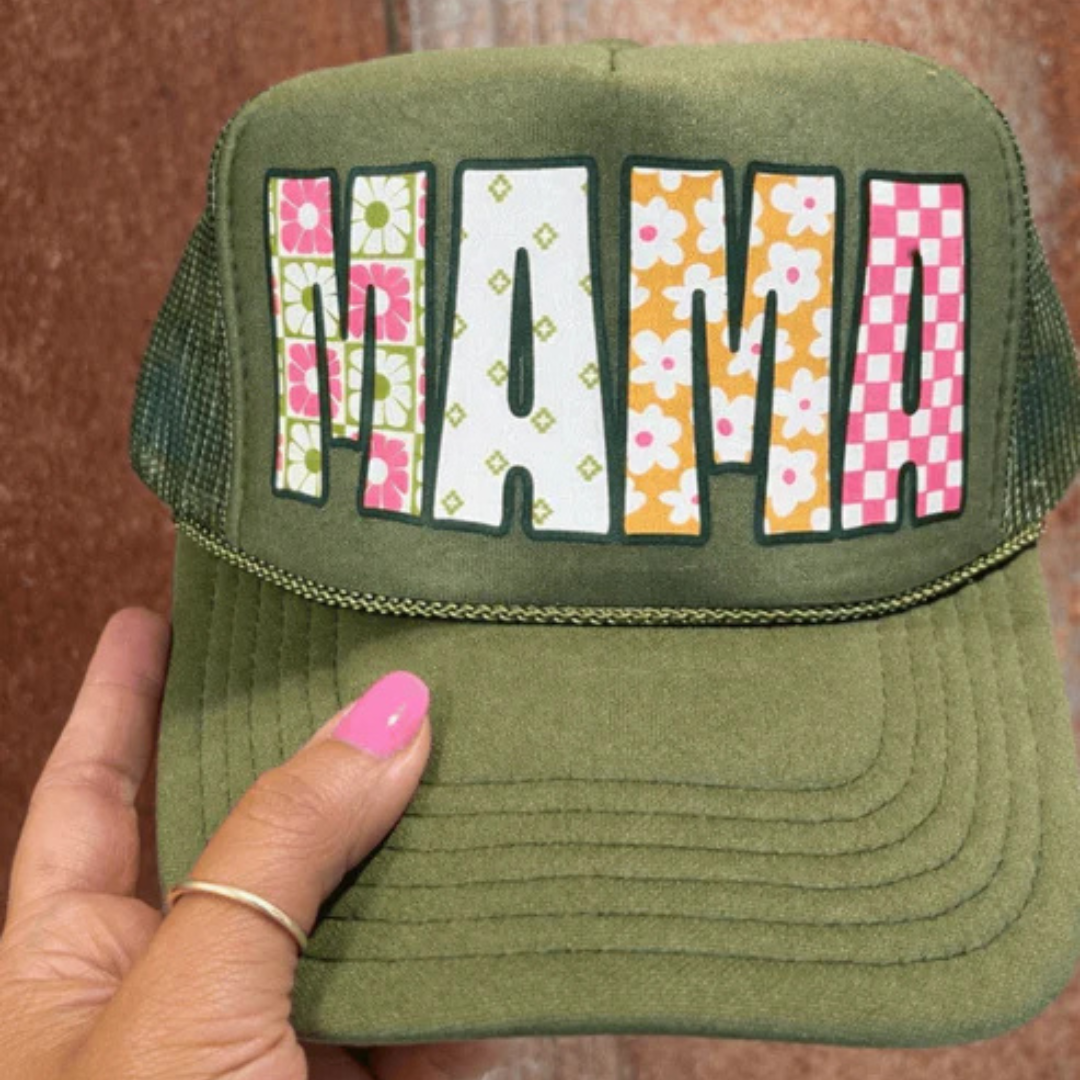 Olive green trucker hat featuring colorful patterned MAMA lettering with floral and gingham details.