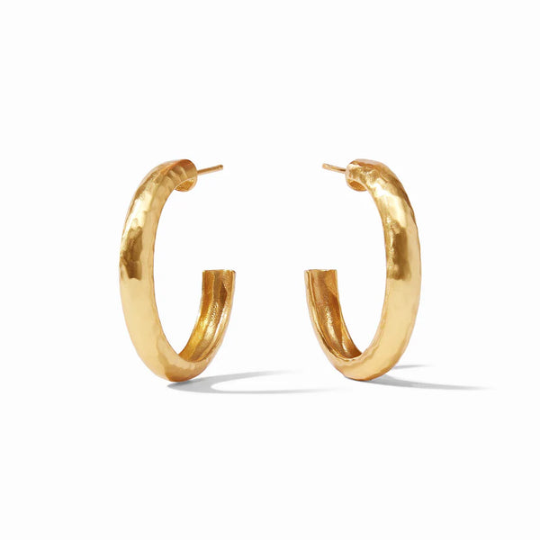 Pictured is a pair of gold, hammered earrings on a white background. 