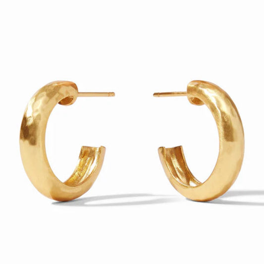 Pictured is a pair of gold, hammered earrings on a white background. 