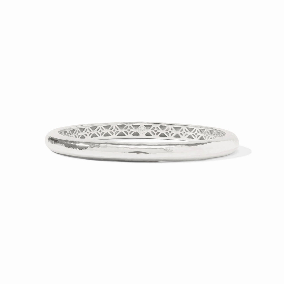 Silver bangle with intricate design on a white background
