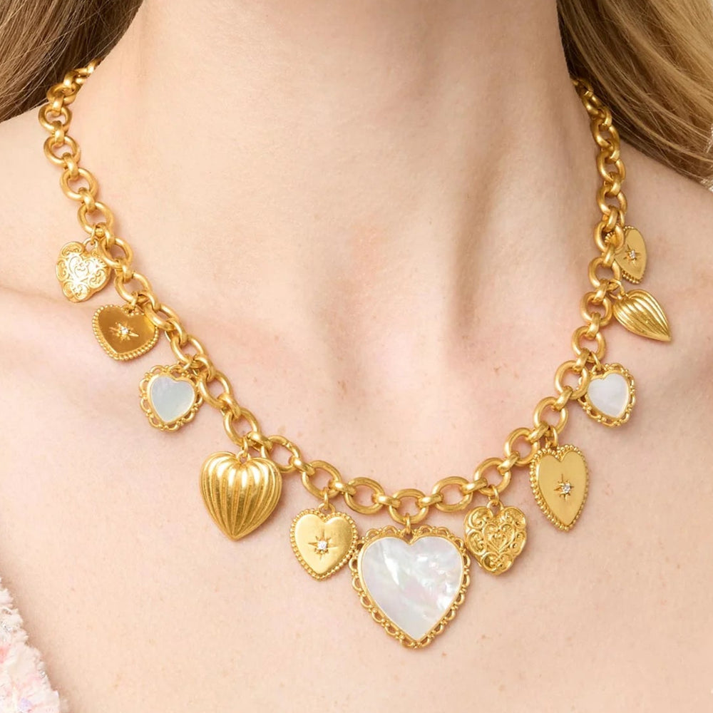 Gold necklace with heart-shaped pendants worn by a person