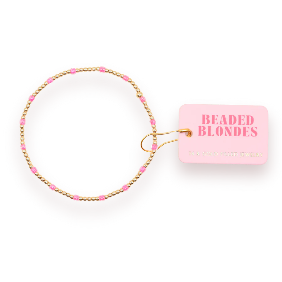 Add a bold pop of color to your stack with the Hot Pink Dainty Poppi Bracelet, a perfect blend of elegance and fun. This bracelet features a mix of 2mm and small Czech glass beads in vibrant hot pink, paired with 14K gold-filled detailing for a touch of luxury.

Carefully hand-strung in College Station, Texas by the talented Beaded Blondes duo, this bracelet is designed to keep up with your busy lifestyle. It's water-resistant, workout-proof, and tarnish-proof, making it perfect for everyday wear.
