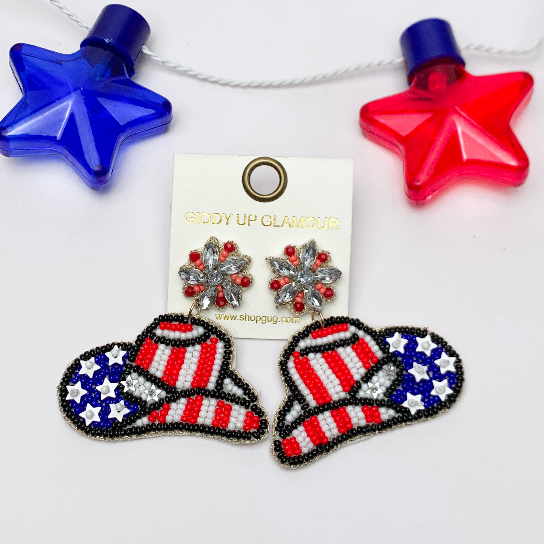 Patriotic Cowboy Hat Beaded Earrings. Pictured on a white background with a red and blue star above the earrings for decoration.