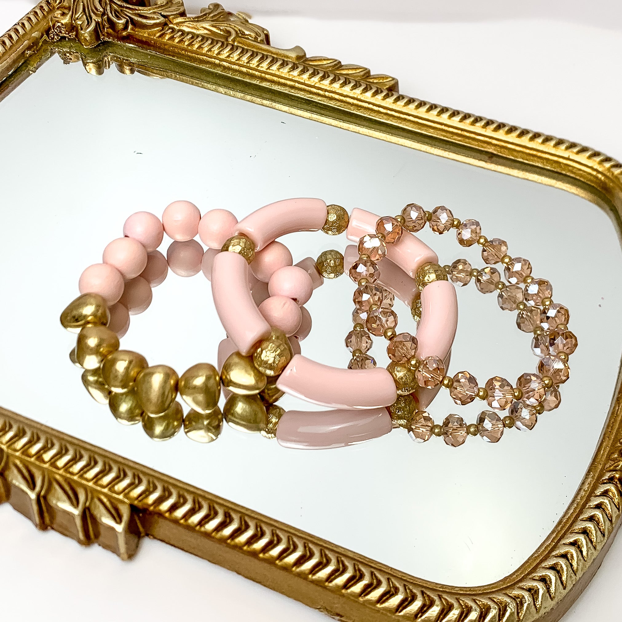 Set of Three | Island Dream Crystal and Marble Beaded Bracelet Set in light pink. Pictured on a white background laying on a mirror with a gold trim.