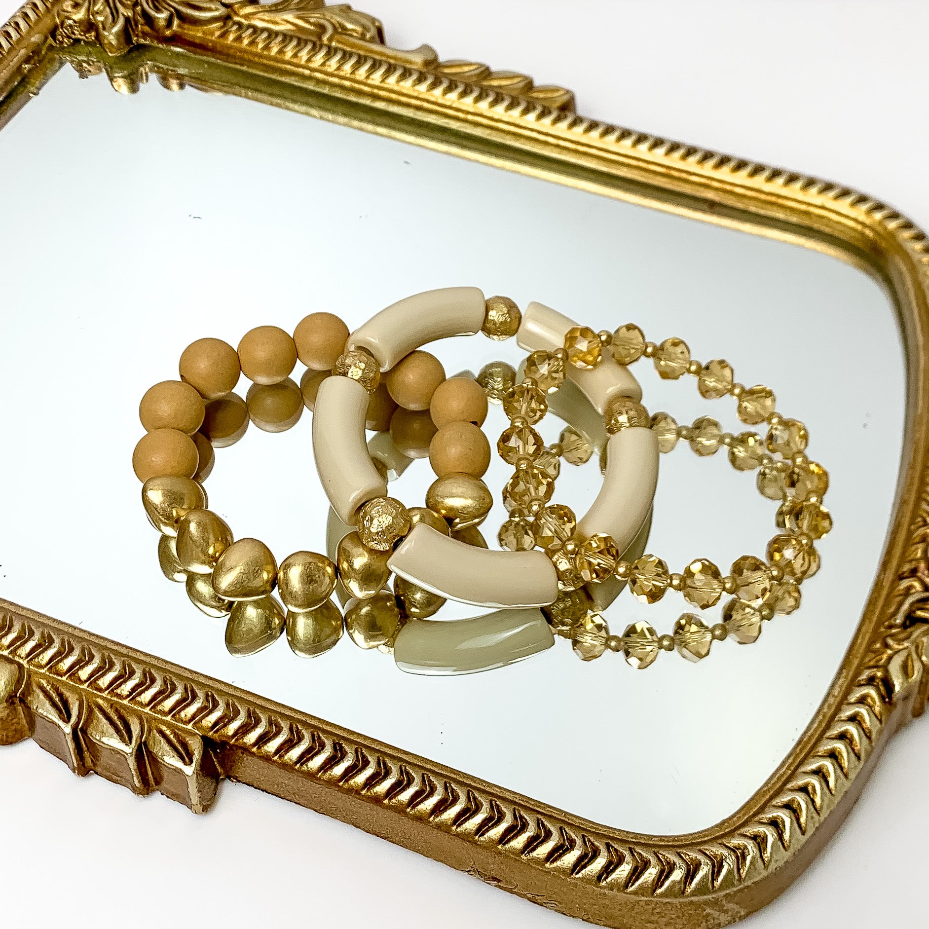 Set of Three | Island Dream Crystal and Marble Beaded Bracelet Set in Beige Brown. Pictured on a white background laying on a mirror with a gold trim.