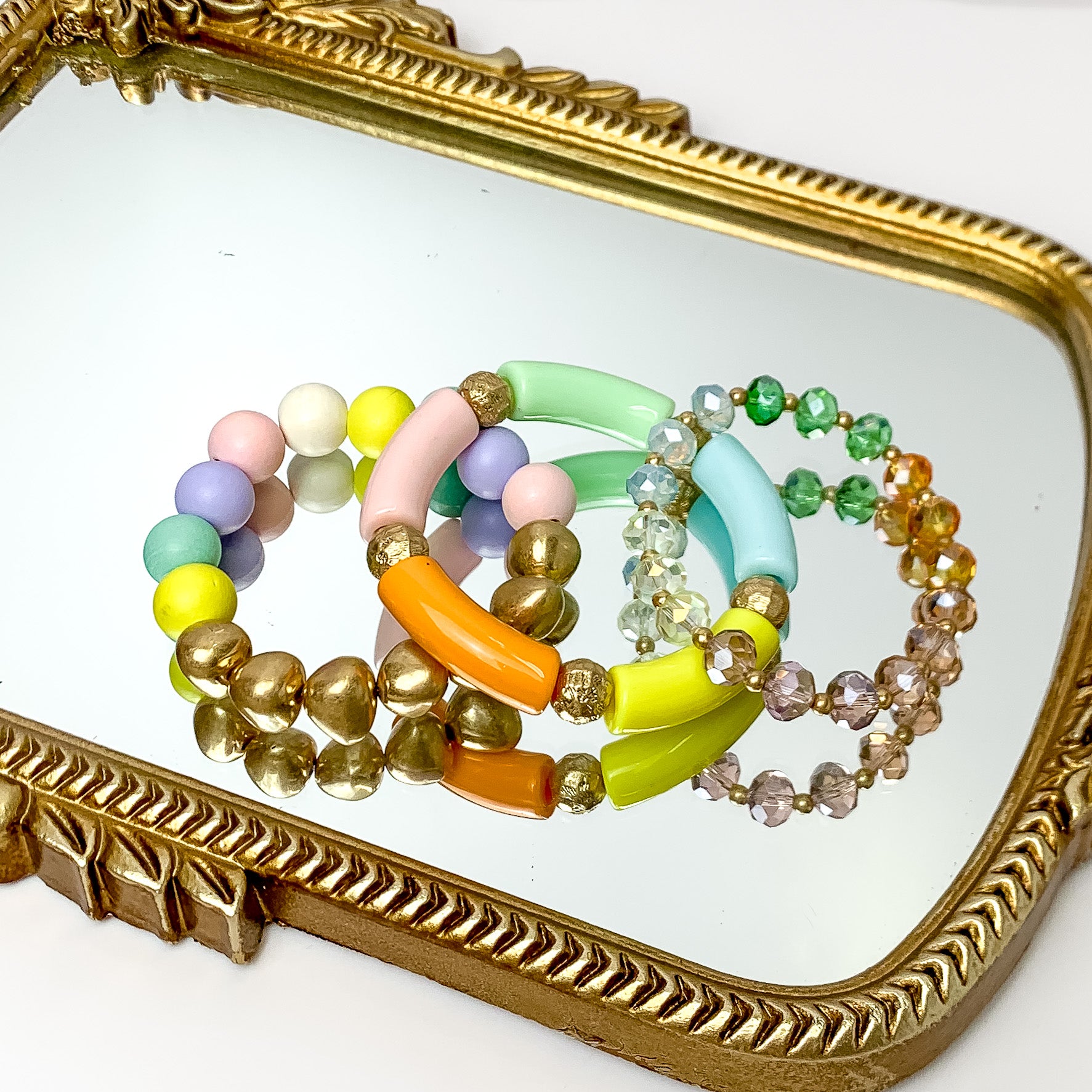 Set of Three | Island Dream Crystal and Marble Beaded Bracelet Set in multicolor. Pictured on a white background laying on a mirror with a gold trim.