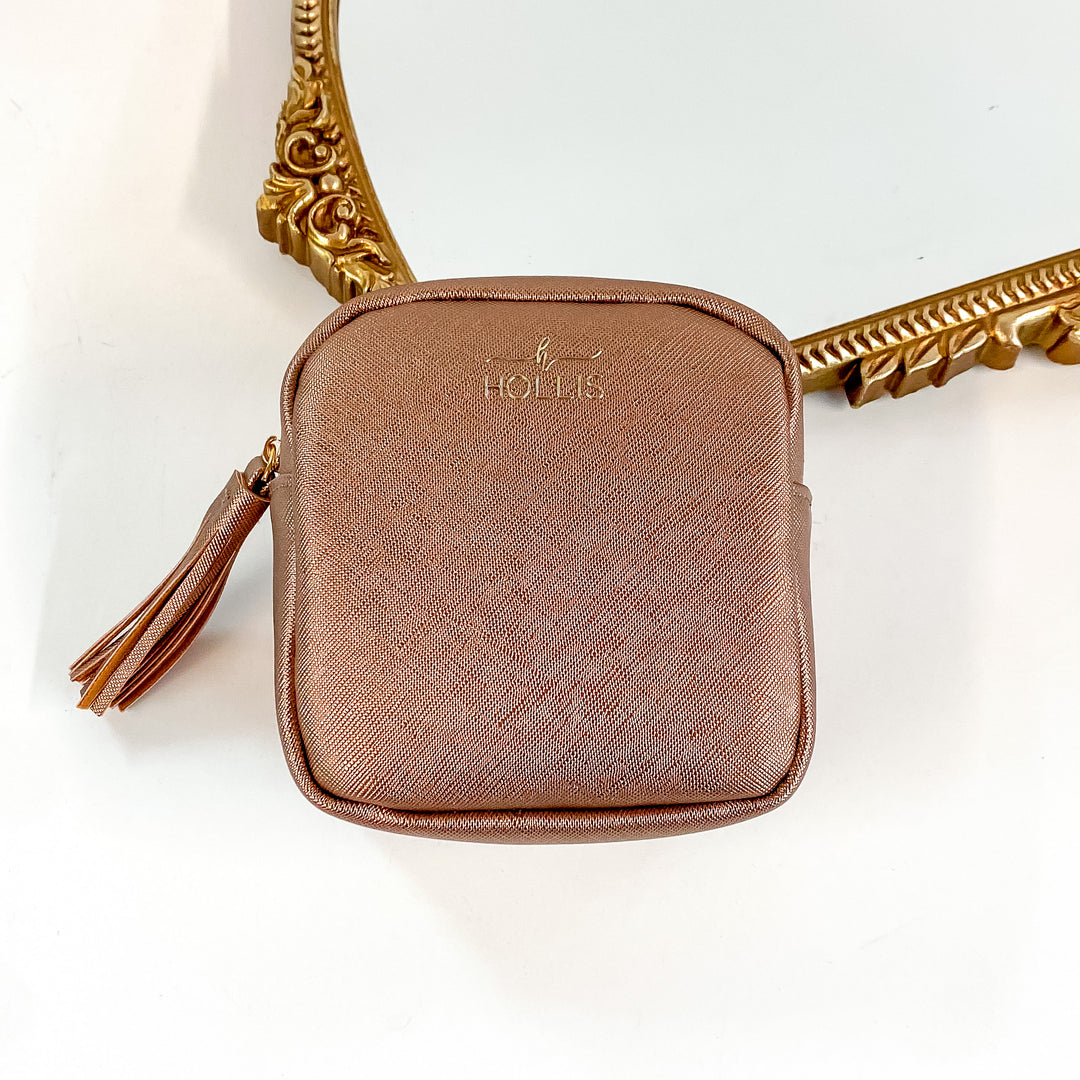 Hollis brand technology organizer in metallic mocha. Smaller square zip up bag. Pictured on a white background with a frame behind the bag.