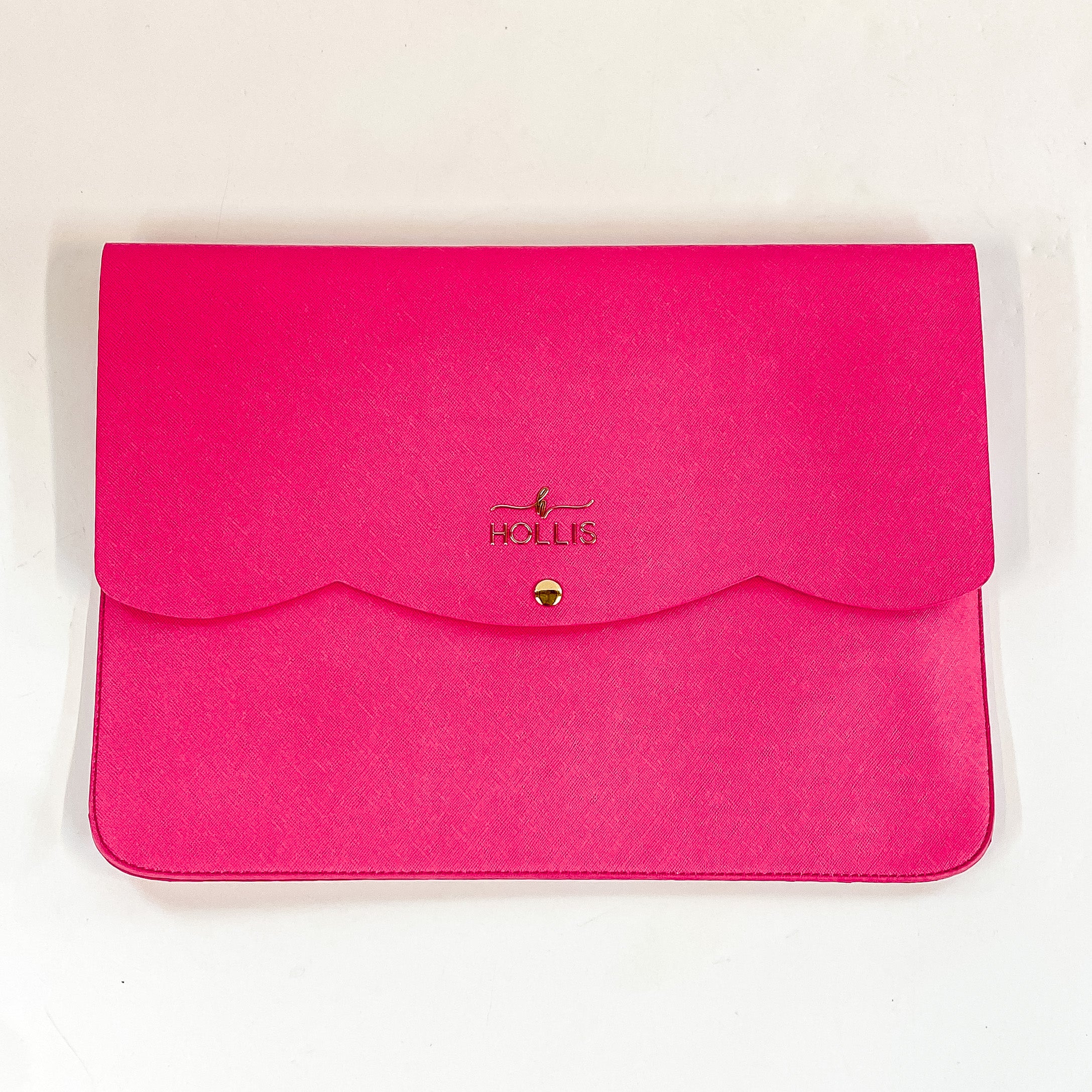 Hollis brand hot pink laptop sleeve. Opens and buttons down in the front. Pictured on a white background.