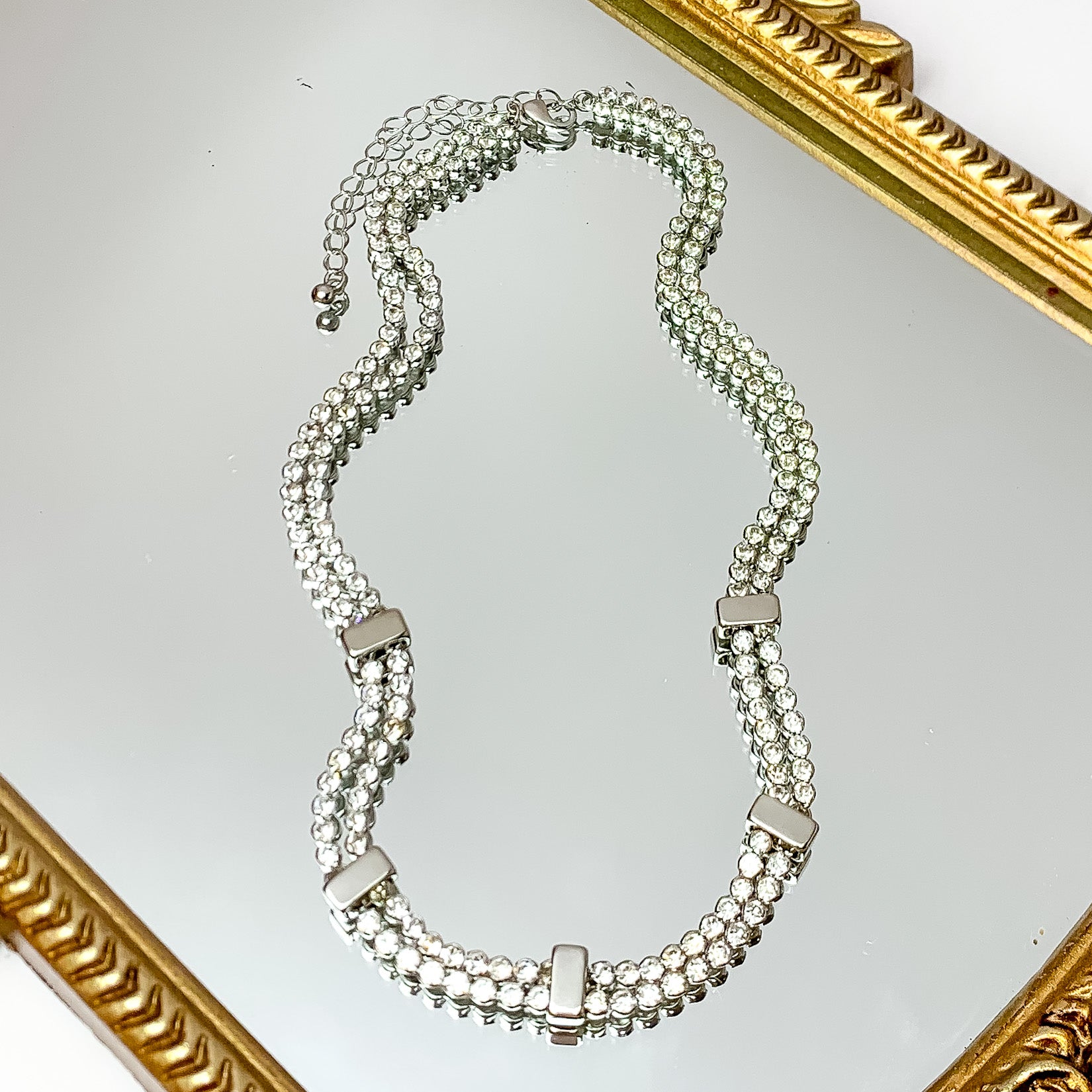 Glam Girl Silver Tone Necklace Outlined in Clear Crystals. Pictured on a white background with disco ball accessories on the left side.