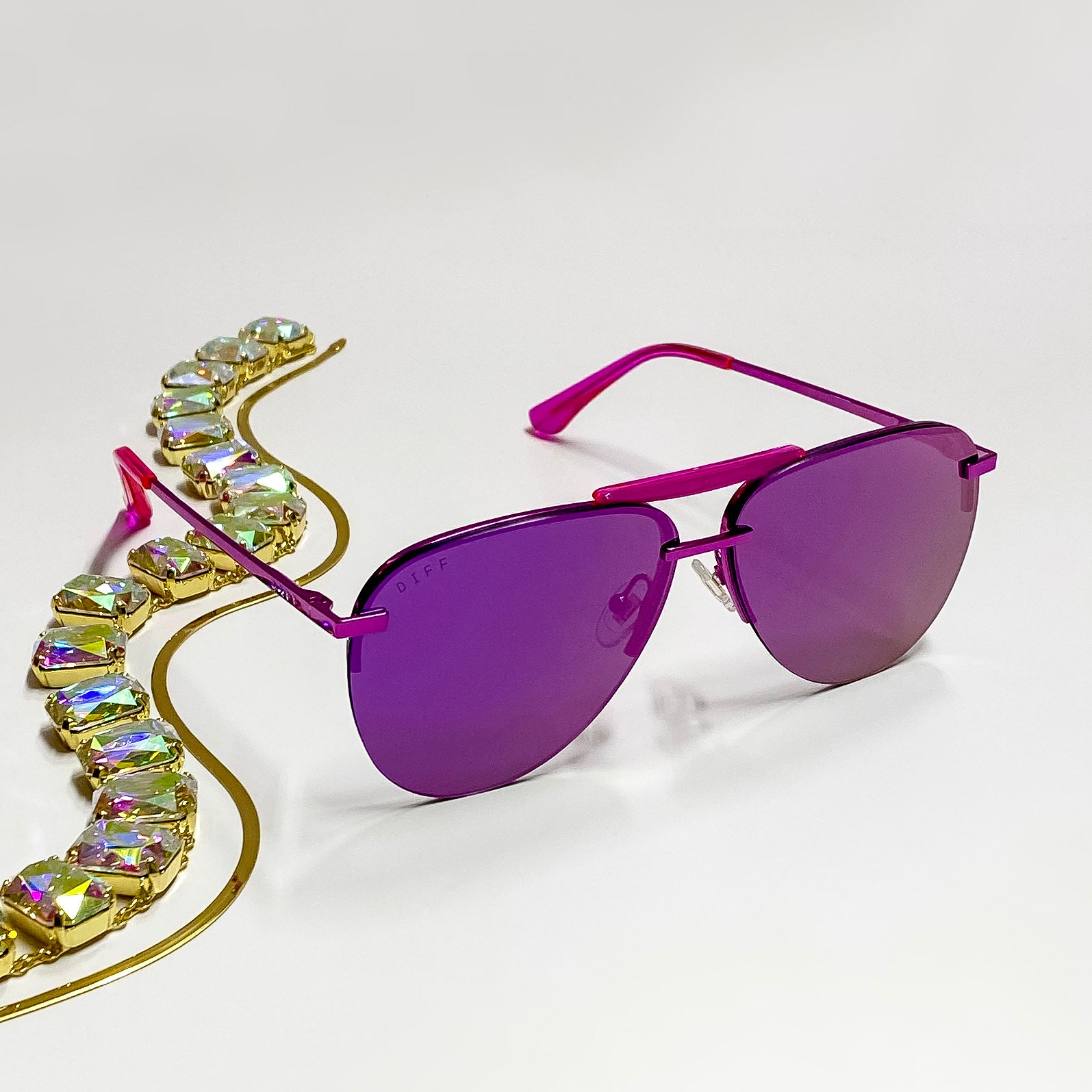 A pair of pink metallic aviator style sunglasses. (Whole sunglass is pink)