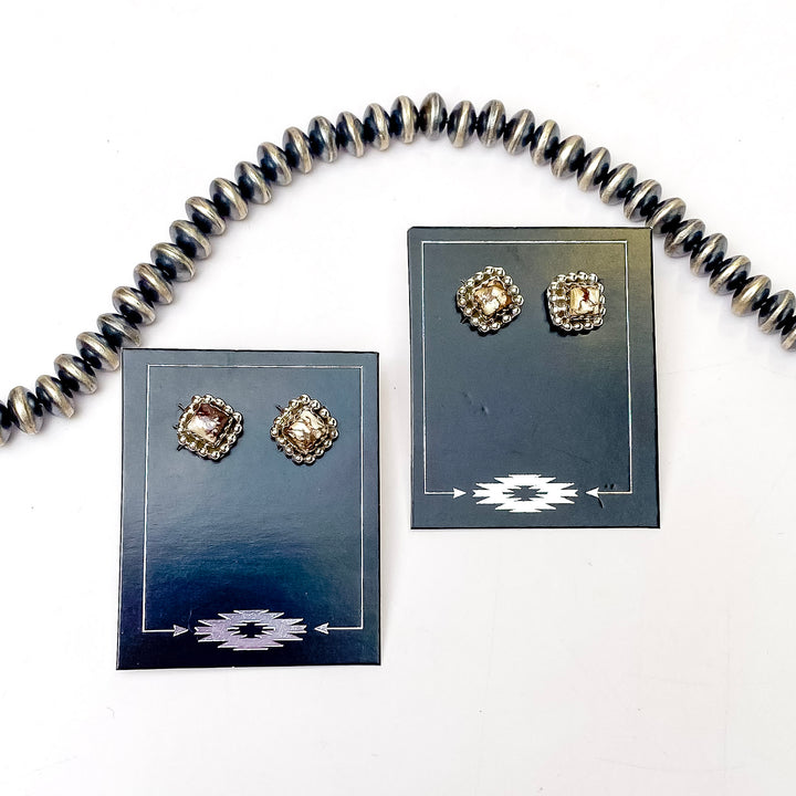 In the picture are square stud earrings with a wild horse remix stone with a white background