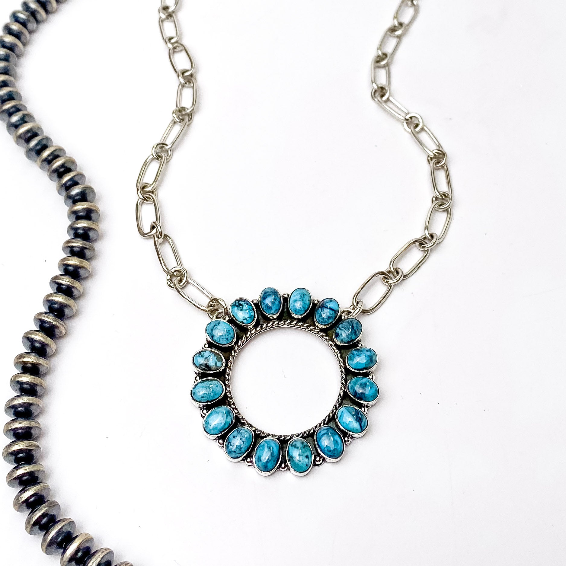 In the picture is a chain circle necklace in kingman turquoise with a white background
