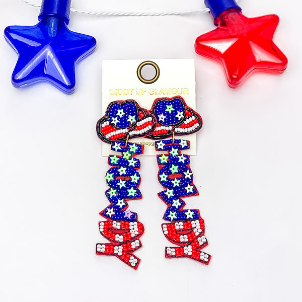 Cowboy hat shaped post earrings with white and red stripes and a blue part with star sequins. These earrings have pendants that spell out "HOWDY." Half has blue beads and white sequin stars. The other half has white and red beads in a striped pattern. These earrings are pictured on a white background. 