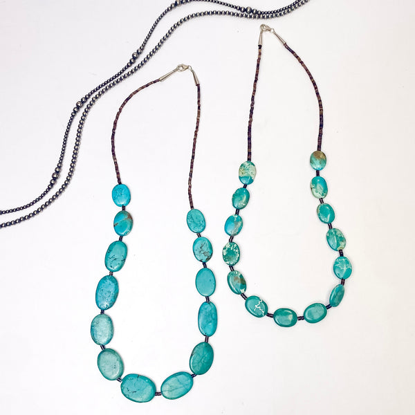 In the picture is a oval shaped necklace in turquoise with a brown heishi bead spacers