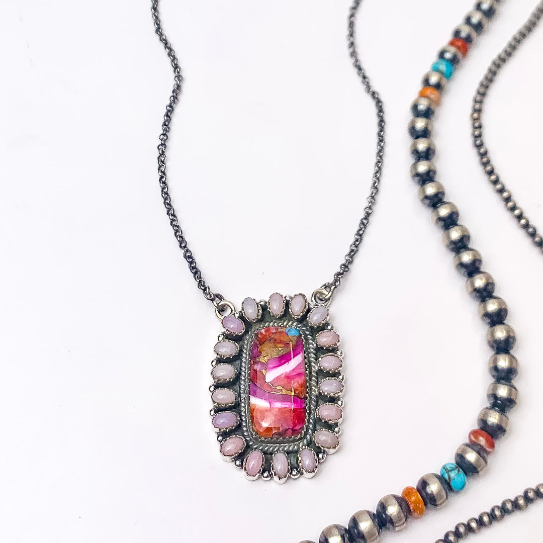 In the picture is a handmade sterling silver adjustable chain with a square circle pendant in multi-stone with a white background