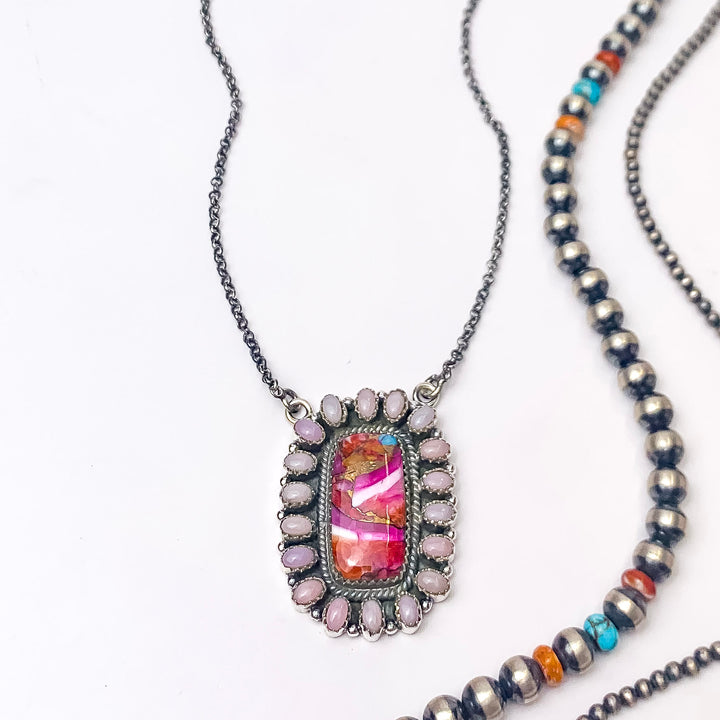 In the picture is a handmade sterling silver adjustable chain with a square circle pendant in multi-stone with a white background