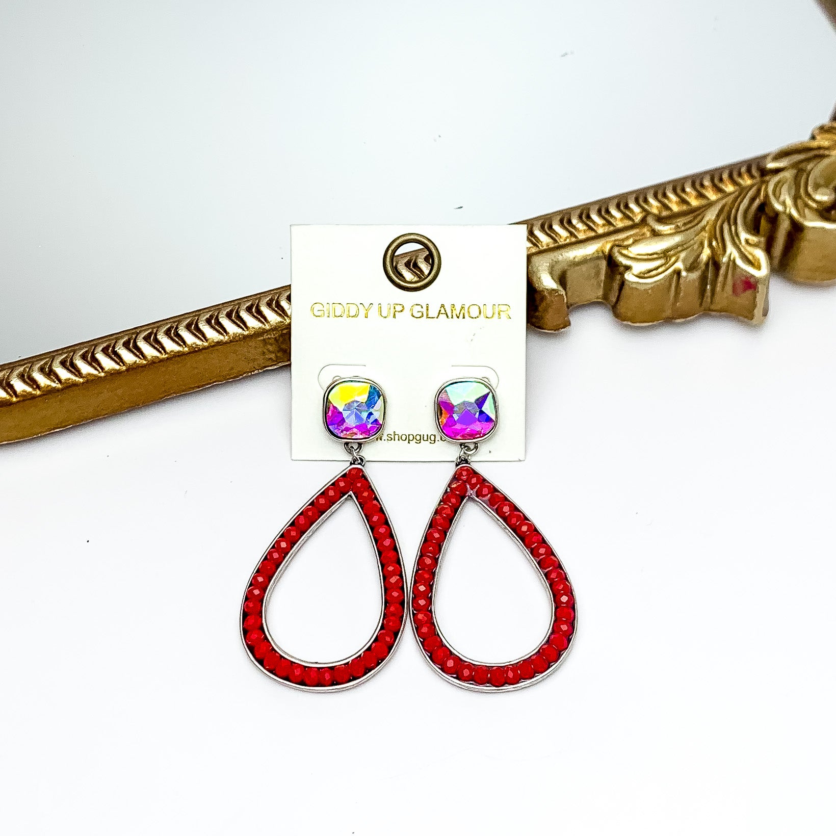 Glass Beaded Teardrop Post Earrings with AB Crystal in Red. Pictured on a white background with a gold frame behind the earrings.
