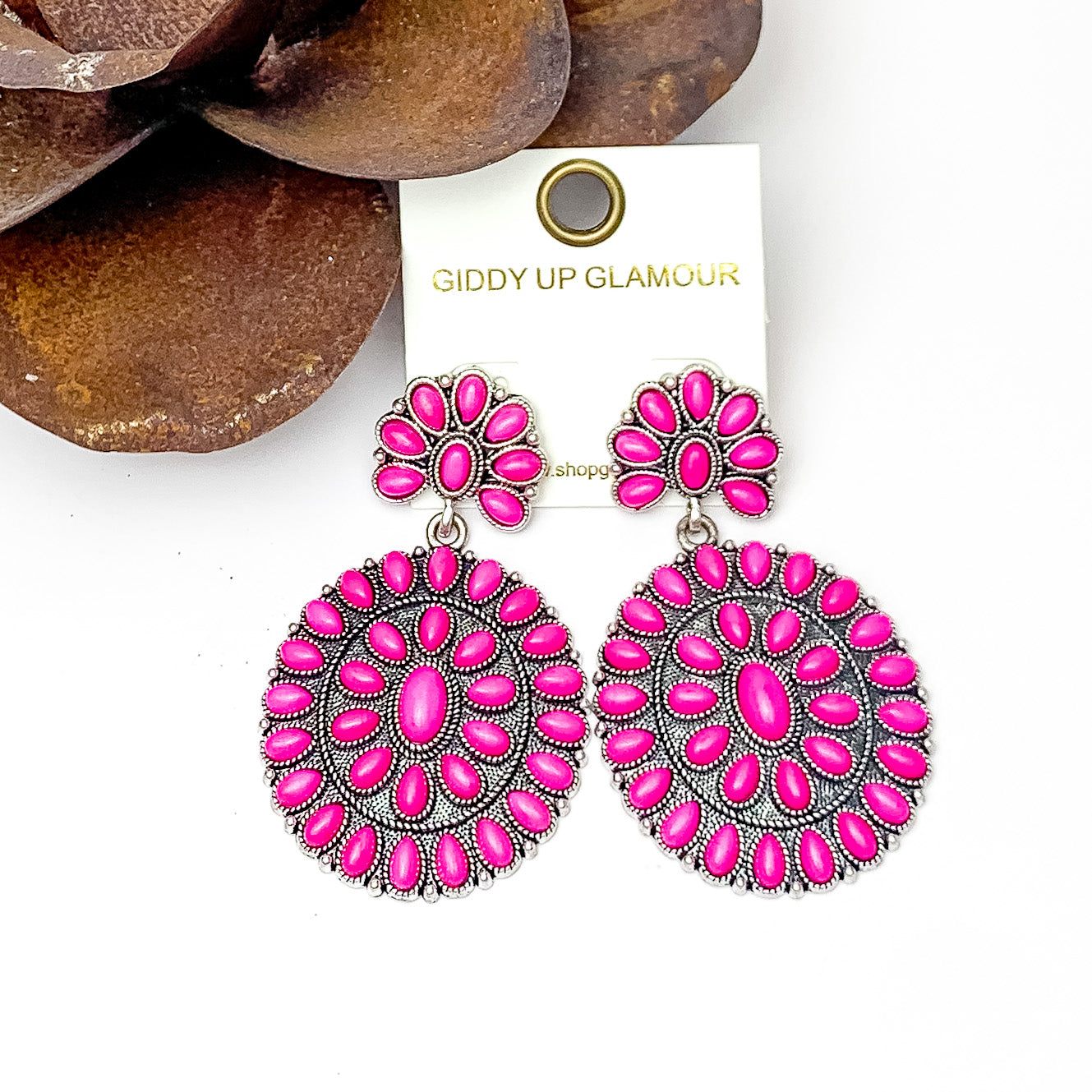 Double Cluster Western Earrings in Fuchsia. Pictured on a white background with a metal rose in the top let corner.