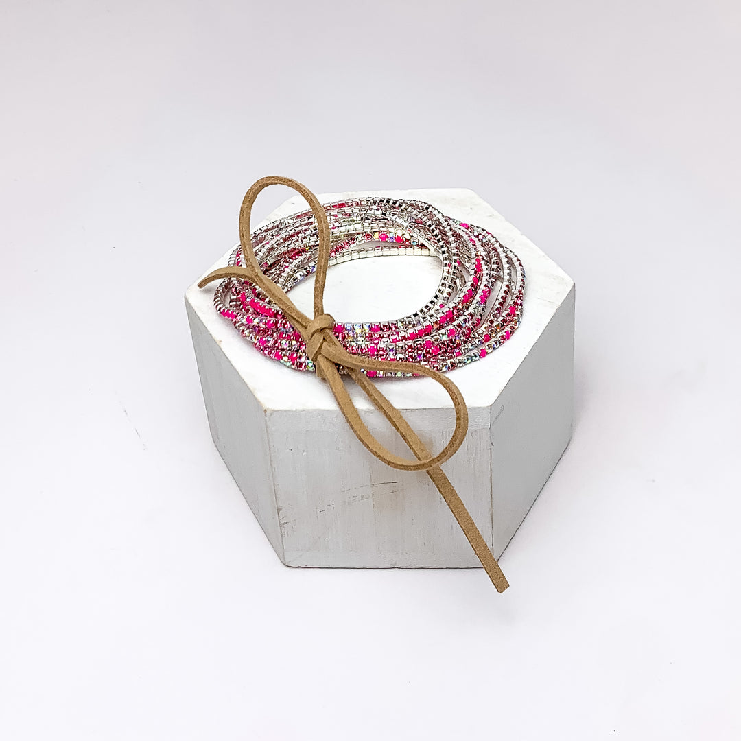 Day Party Crystals Stretchy Bracelet Set With Bow in Dark Pink. Pictured on a white background with the bracelets sitting on a white podium. 