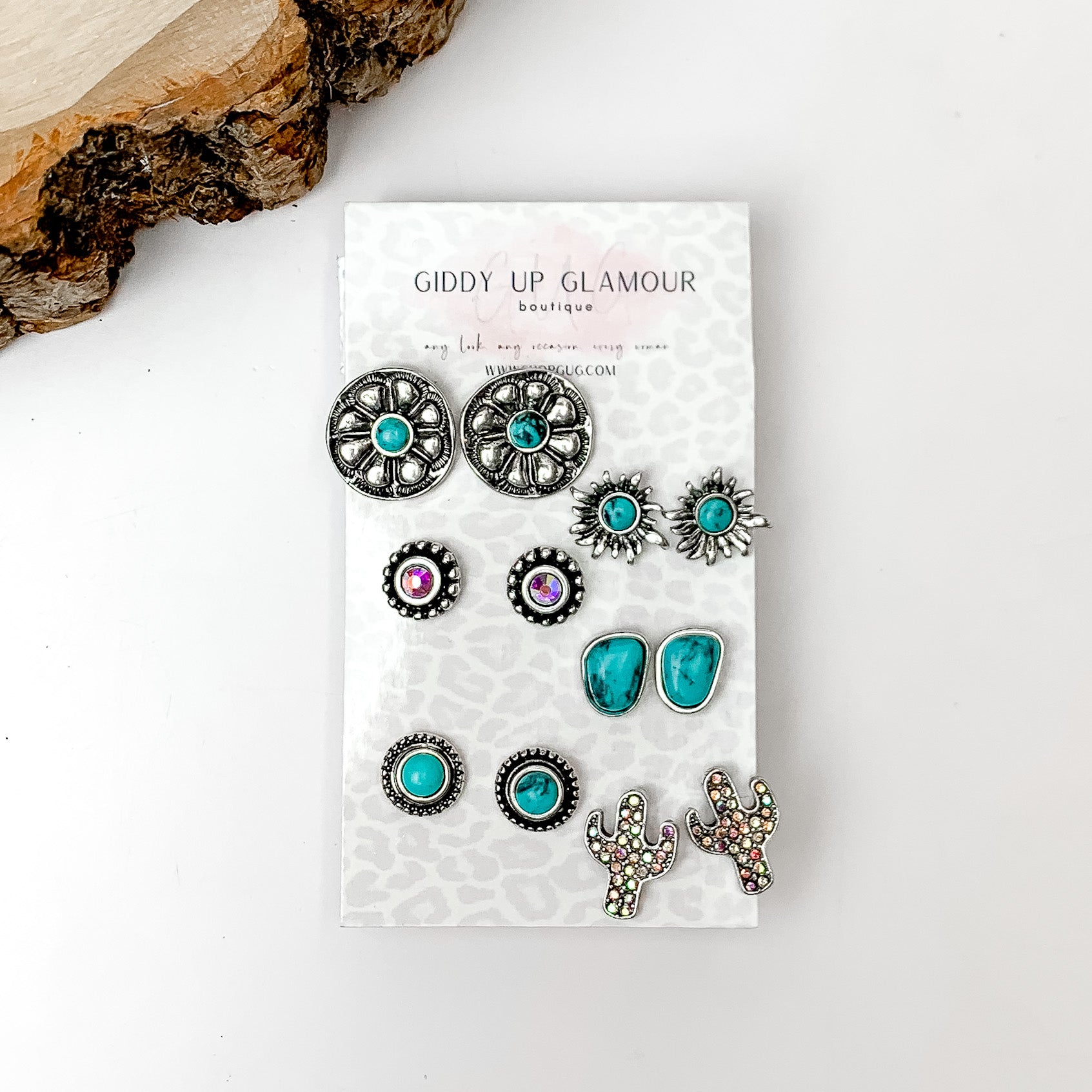 Set Of Six | Western Flower Turquoise and Silver Tone Stud Earrings. Pictured on a white background with a wood piece in the top left corner.