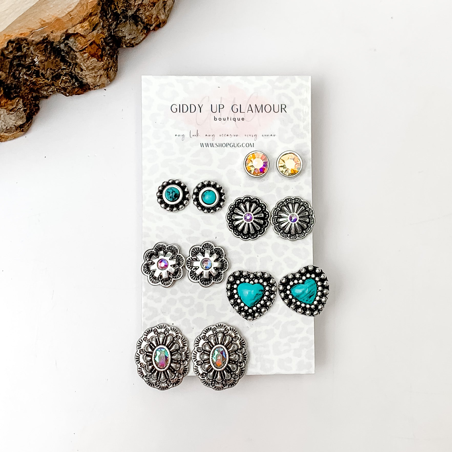 Set Of Six | Western Flower Designed Turquoise and Silver Tone Stud Earrings. Pictured on a white background with a wood piece in the top left corner.
