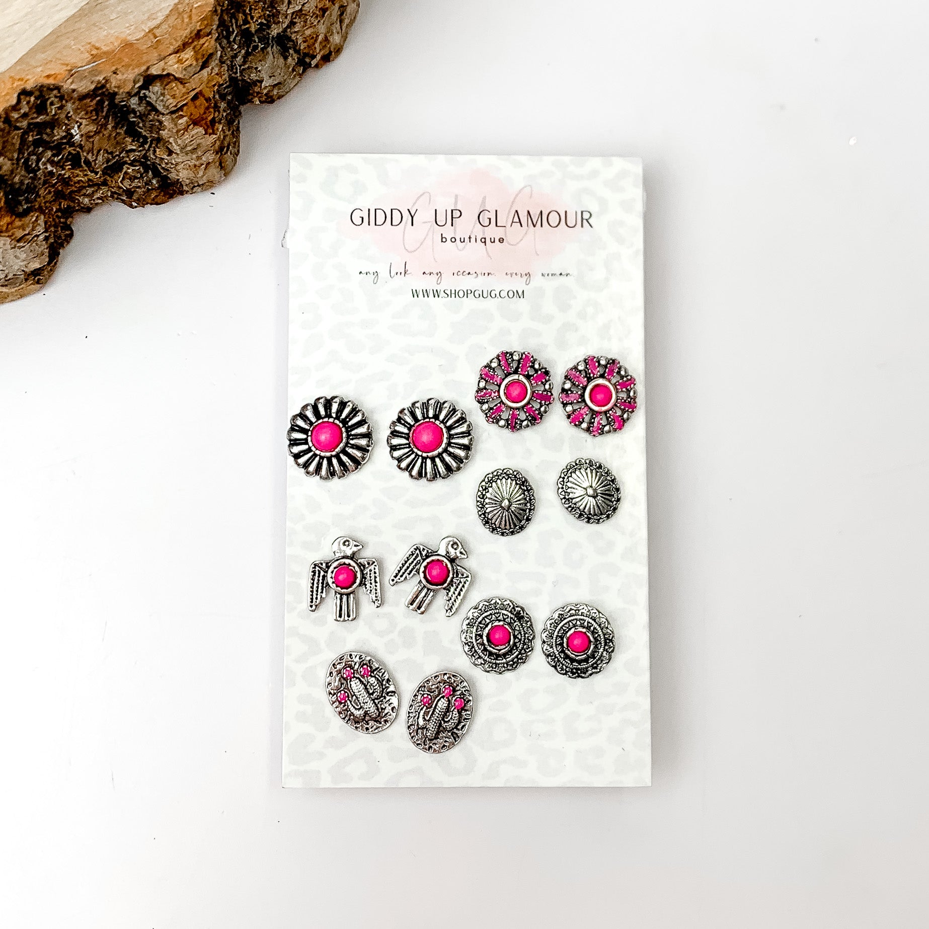 Set Of Six | Multiple Fuchsia Pink and Silver Tone Stud Earrings. Pictured on a white background with a wood piece in the top left.