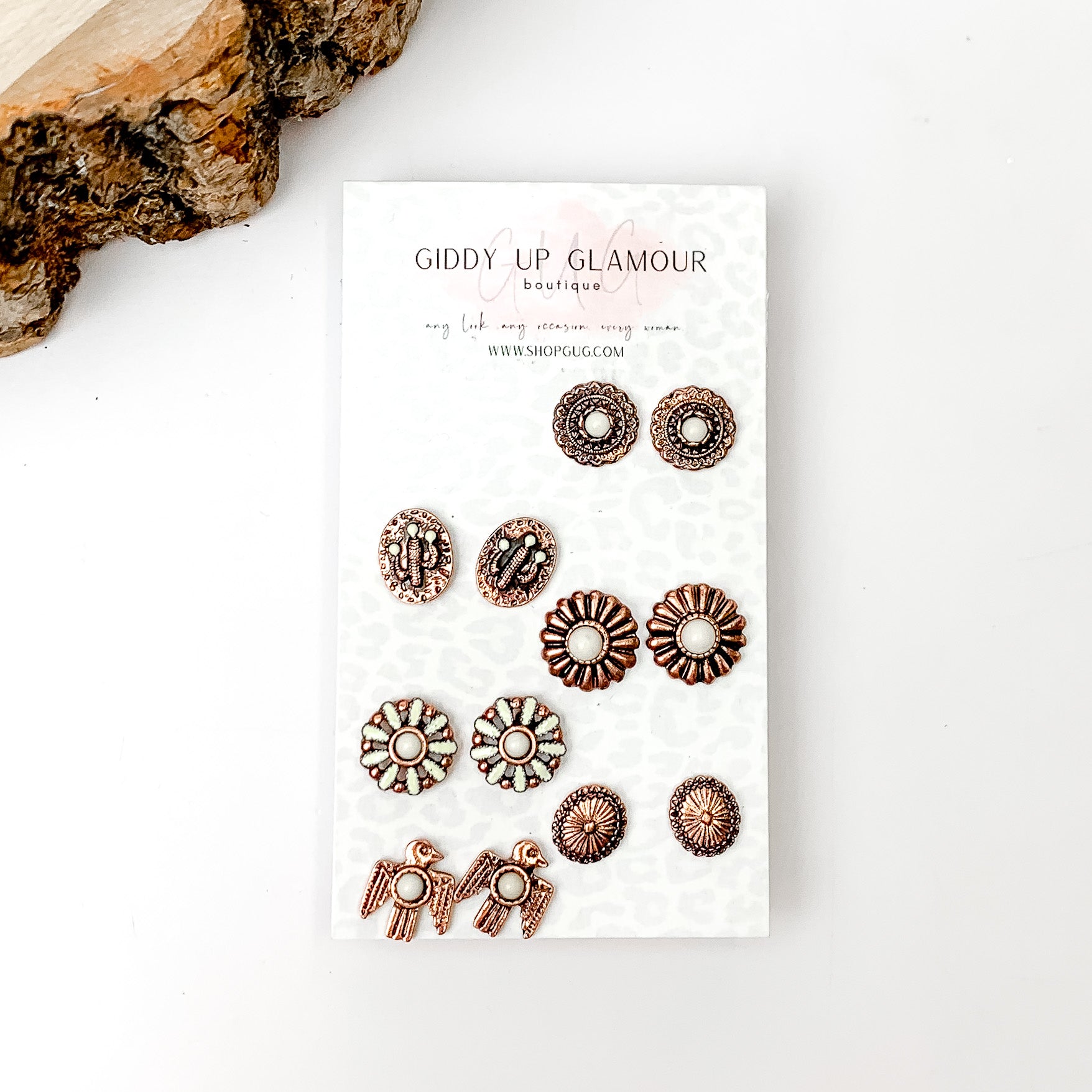 Set Of Six | Multiple Ivory and Copper Tone Stud Earrings. Pictured on a white background with a wood piece in the top left.