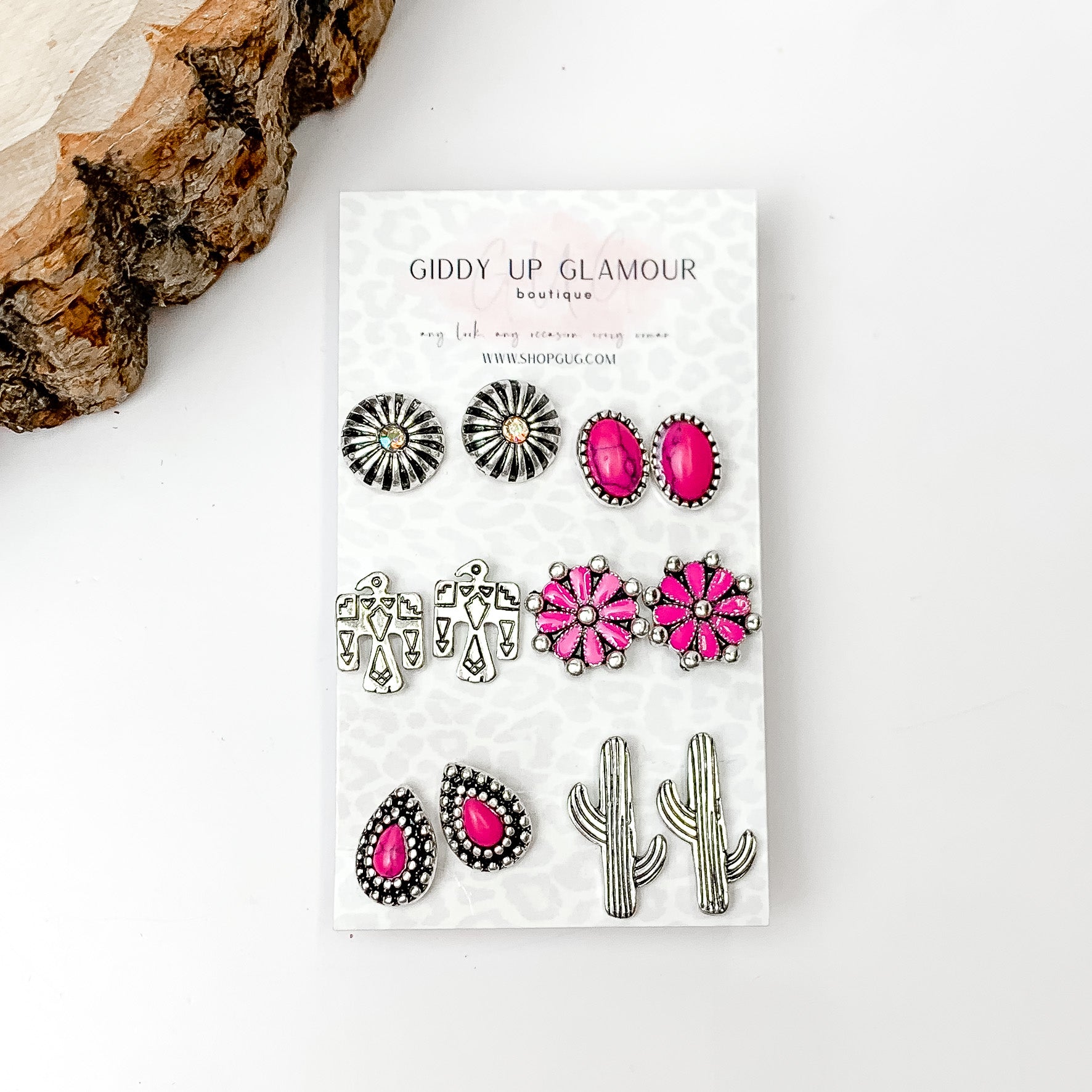 Set Of Six | Western Themed Fuchsia Pink and Silver Tone Stud Earrings. Pictured on a white background with a wood piece in the top left corner.