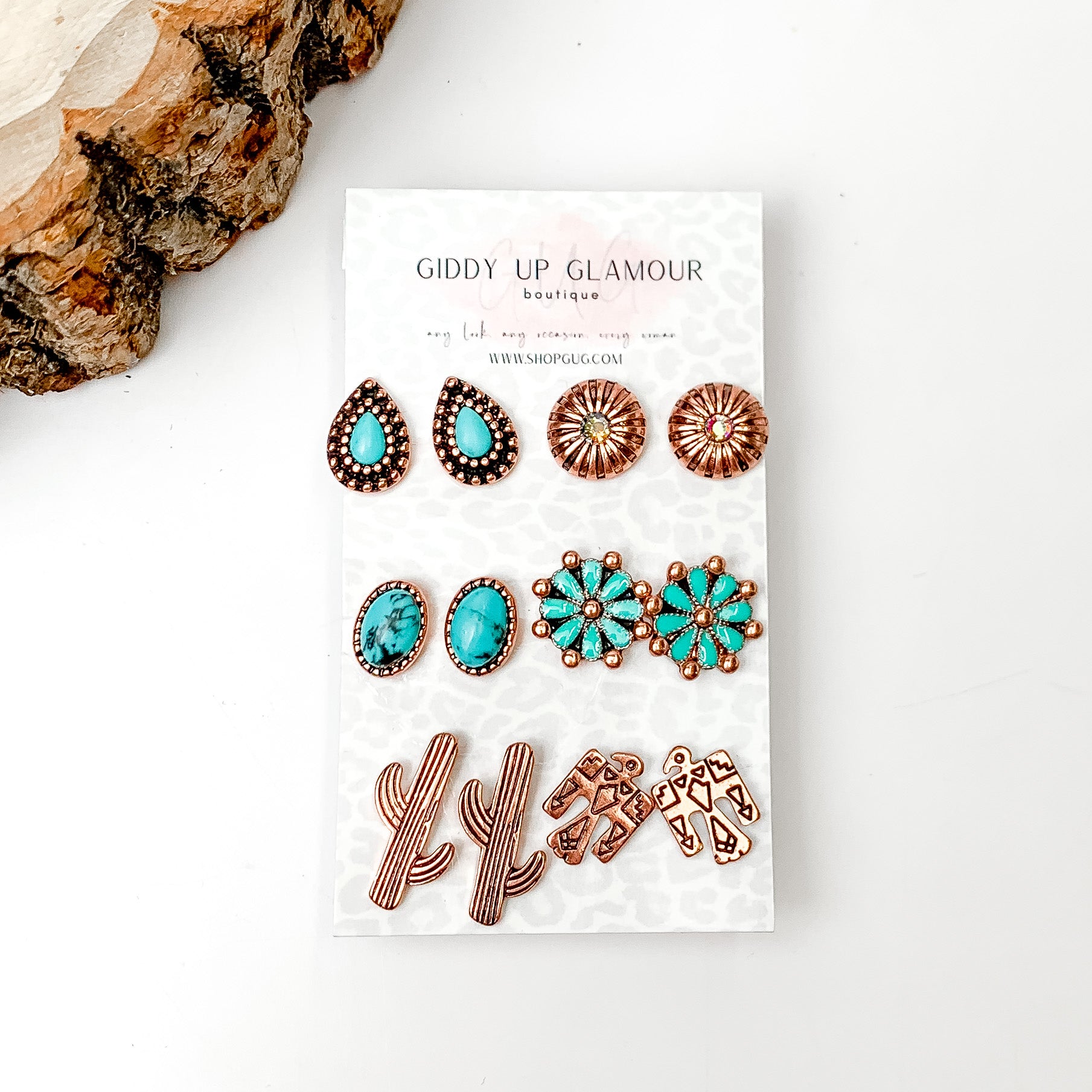 Set Of Six | Western Themed turquoise and Silver Tone Stud Earrings. Pictured on a white background with a wood piece in the top left corner.
