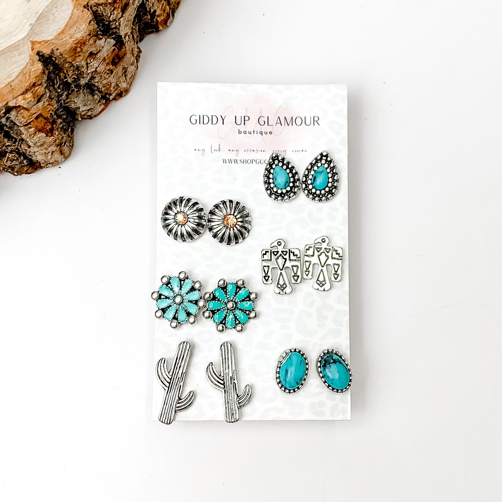 Set Of Six | Western Themed Turquoise and Silver Tone Stud Earrings. Pictured on a white background with a wood piece in the top left corner.