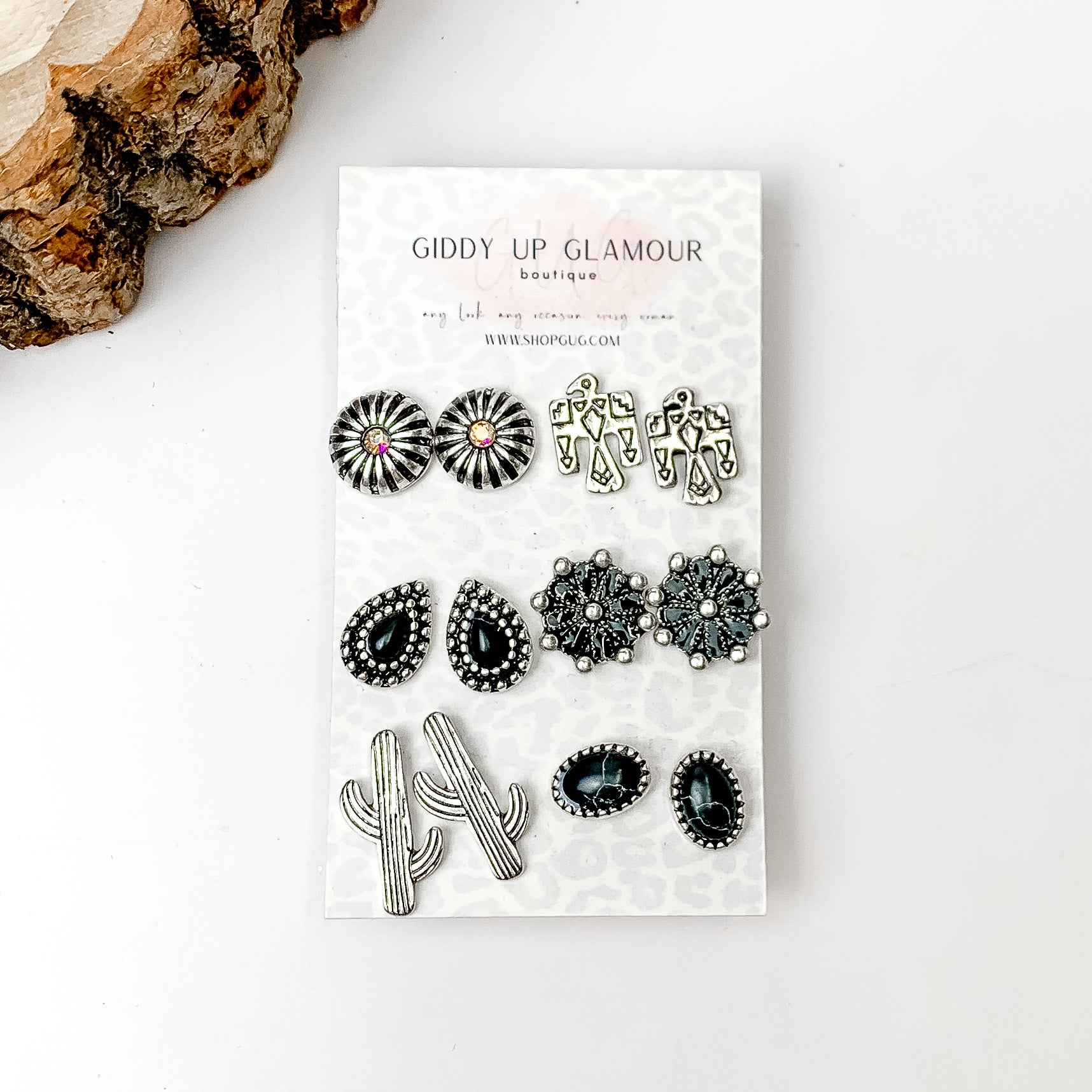 Set Of Six | Western Themed Black and Silver Tone Stud Earrings. Pictured on a white background with a wood piece in the top left corner.