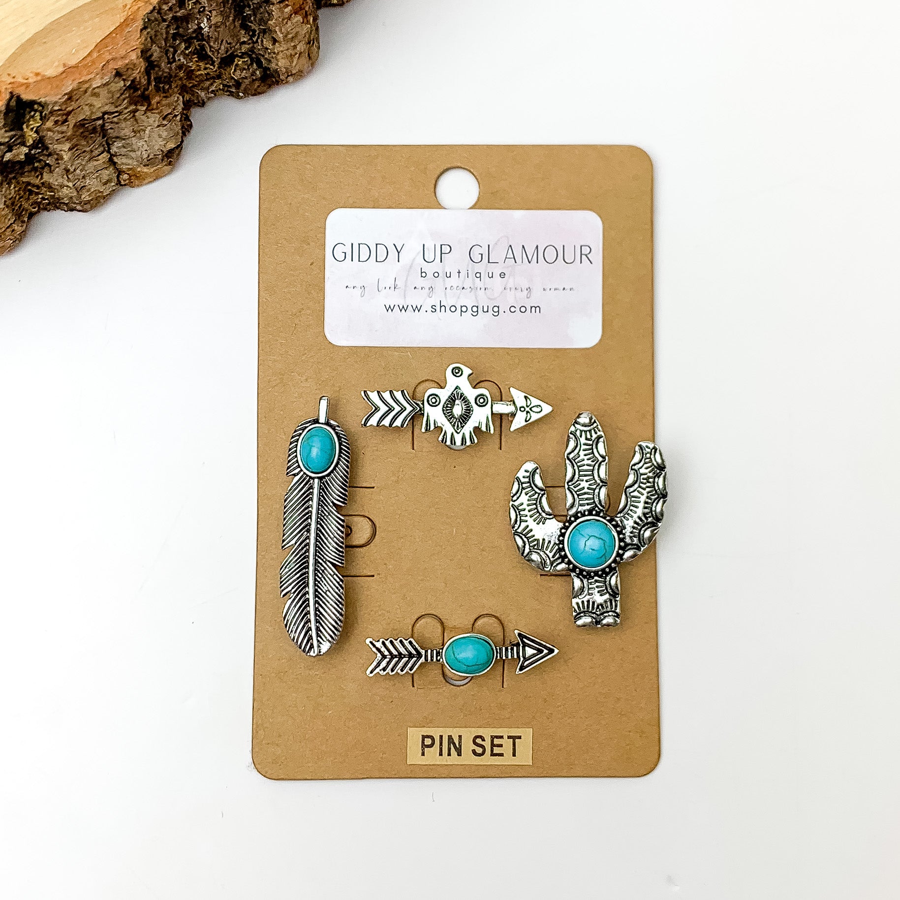 Set of Four | Silver Tone Western Hat Pins With Turquoise Stones. Pictured on a white background with a wood piece in the top left corner.