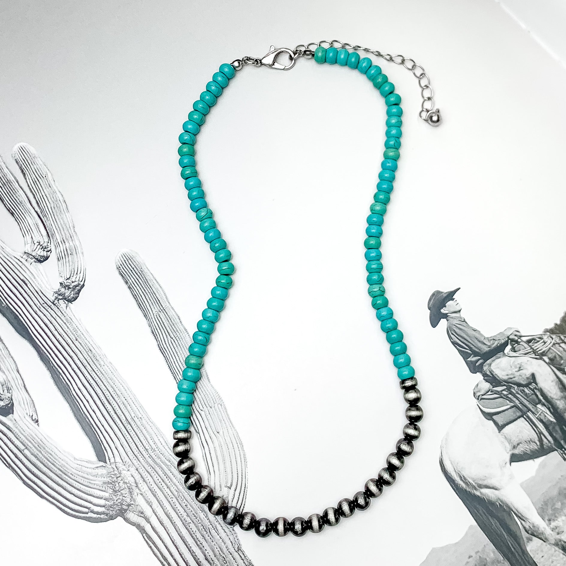 Turquoise Blue and Silver Tone Beaded Necklace. Pictured on a western themed background.