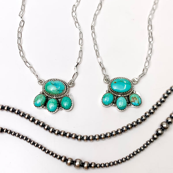 In the picture are handmade sterling silver four circle cluster necklace in kingman turquoise with a white background