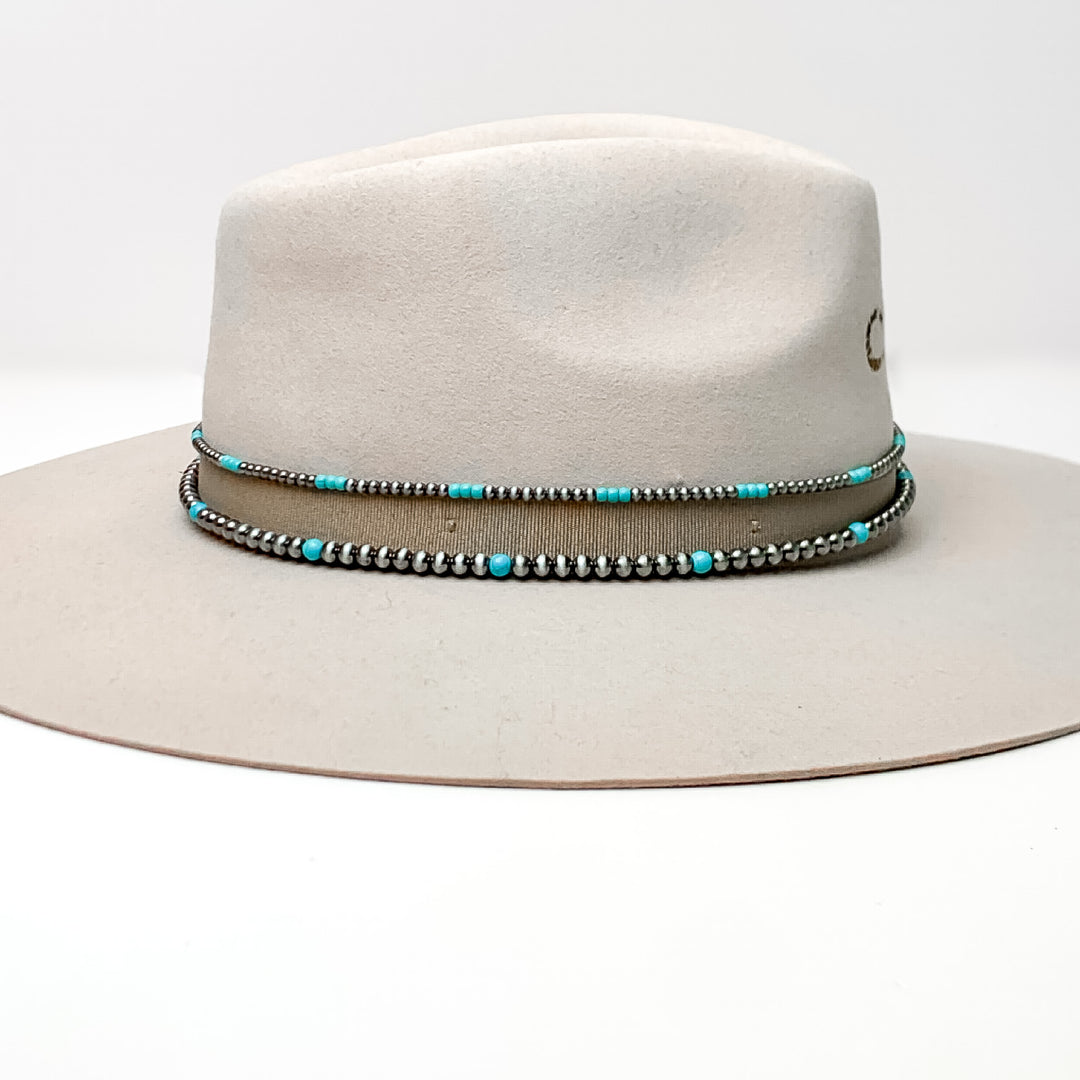 Silver Tone and Turquoise Pearl Hat Band With Brown Tie Strings. Pictured on a white background with the band around a light brown/ gray hat.