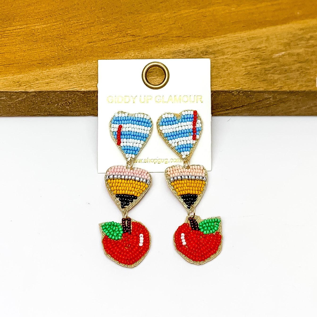 Teaching Inspired Three Tiered Beaded Earrings. Pictured on a white background with the earrings against a wood piece.