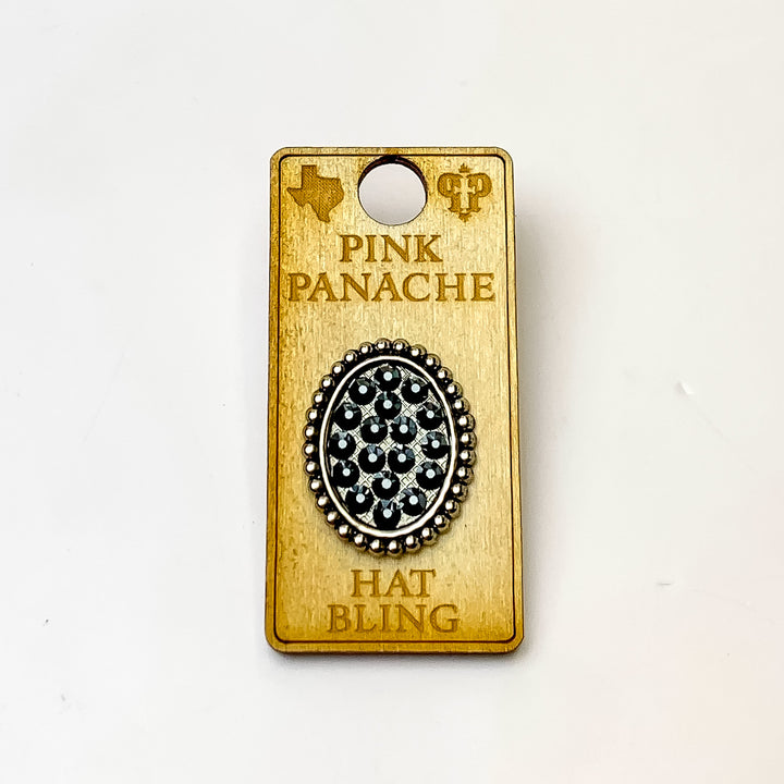 Silver, oval hat pin with a back crystal inlay. This hat pin is pictured on a wooden Pink Panache holder on a white background. 