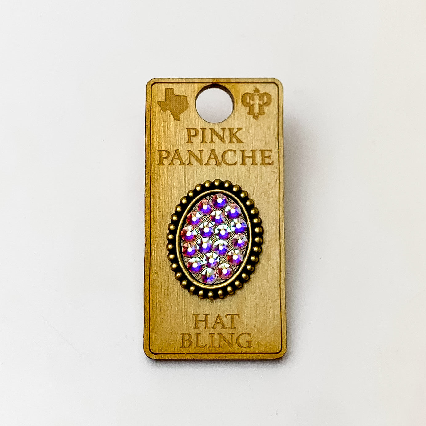 Bronze, oval hat pin with a ab crystal inlay. This hat pin is pictured on a wooden Pink Panache holder on a white background. 