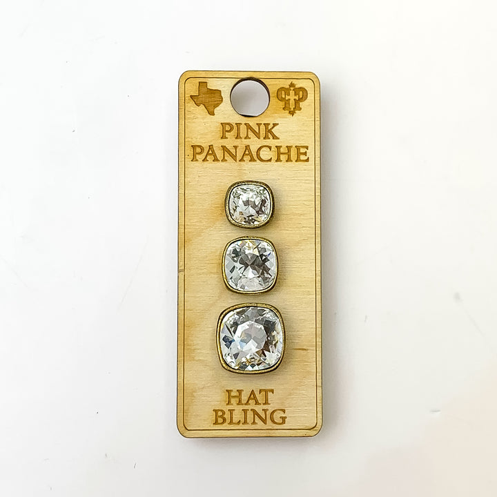 Three bronze, square hat pins going smallest to biggest with clear cushion cut crystal. This hat pin is pictured on a wooden Pink Panache holder on a white background.