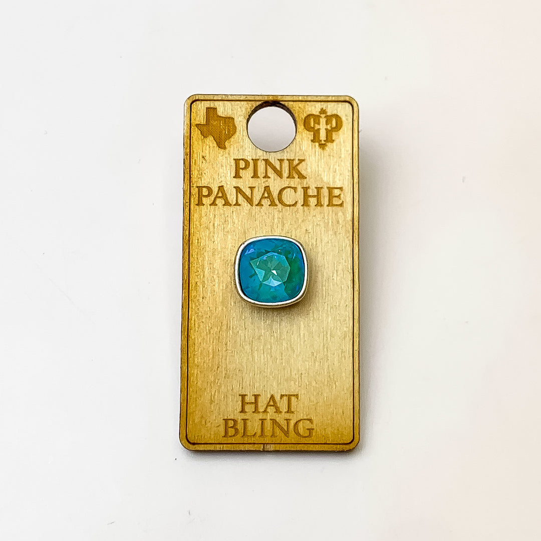 Silver, square hat pin with a laguna delight cushion cut crystal. This hat pin is pictured on a wooden Pink Panache holder on a white background.