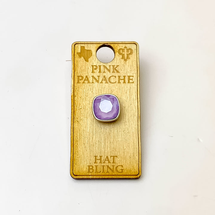Silver, square hat pin with a lilac cushion cut crystal. This hat pin is pictured on a wooden Pink Panache holder on a white background.